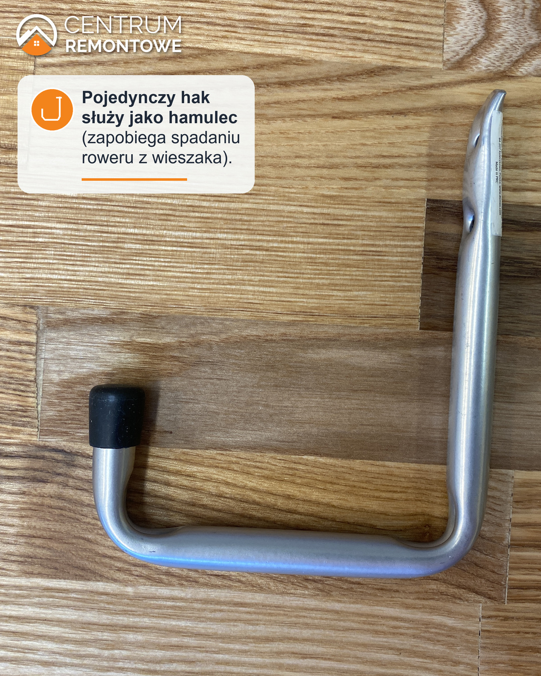 Pojedynczy metalowy hak w kształcie litery L z gumową nasadką, który w przypadku uchwytu na rower służy, jako blokada koła.